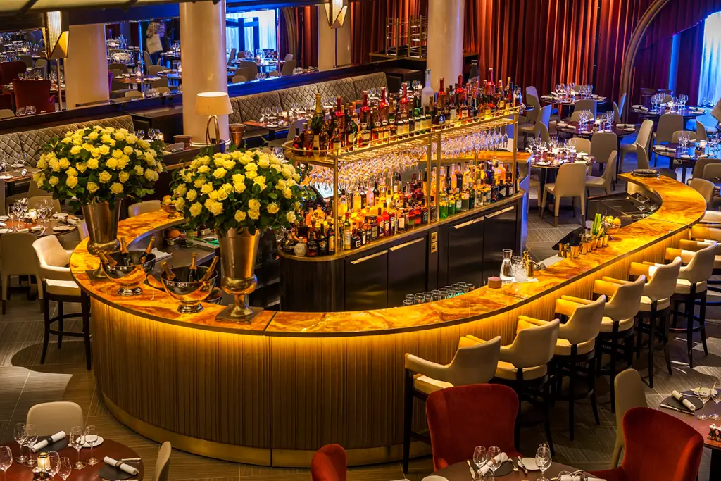 Elegant casino bar with glowing onyx panels, showcasing how natural textures elevate interior design.